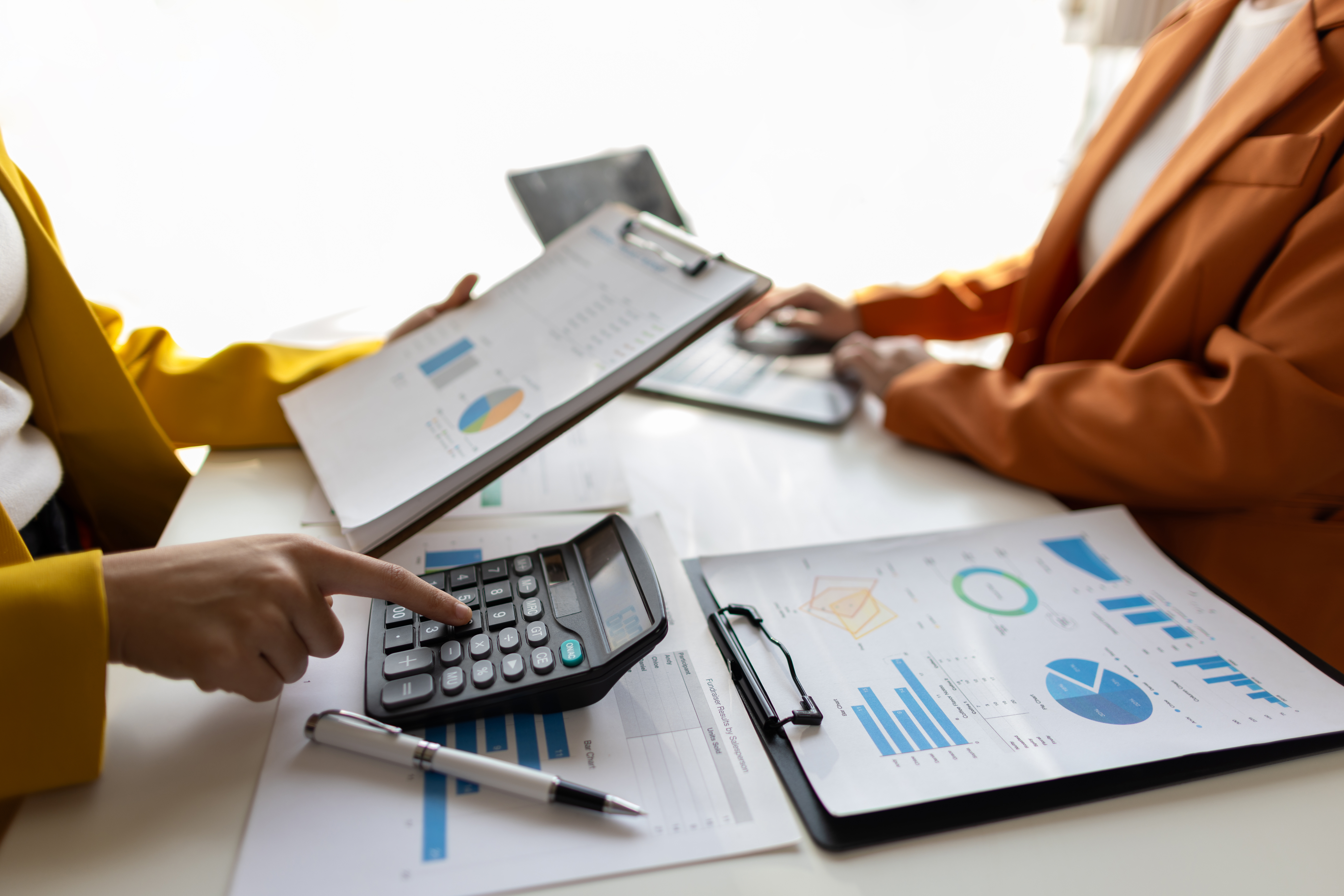 Businesswoman meeting with consultant discussing financial situation analysis in business and marketing report. Financial planning, accounting and business strategy.